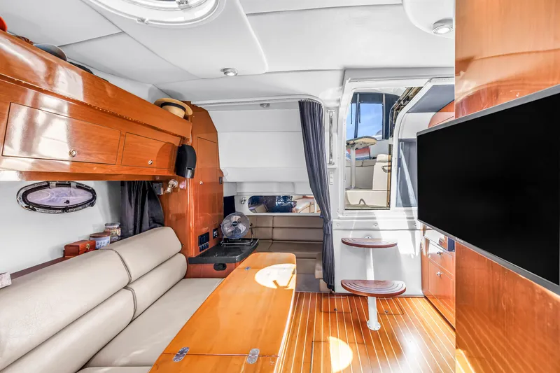 Slide: The Image of Interior of 2007 Regal Commodore 3760 IB yacht with modern furnishings and wood accents. - 8