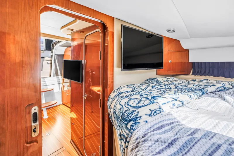 Slide: The Image of Luxurious interior of 2007 Regal Commodore 3760 IB yacht with cozy bed and TV. - 9