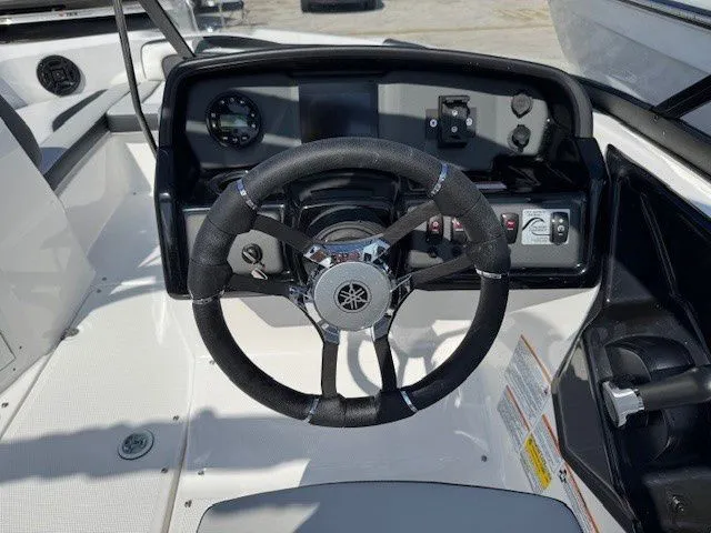 Slide: The Image of Yamaha Boats AR195 2025 steering console with wheel and dashboard. - 22
