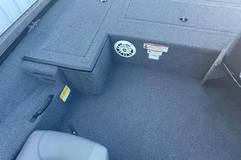 Slide: The Image of 2021 Crestliner XF 179 boat interior with carpeted flooring and speaker. - 11