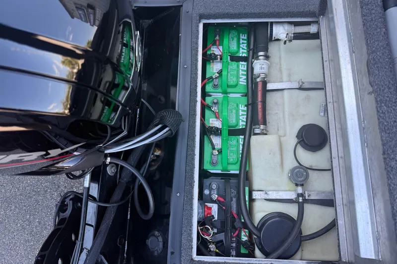 Slide: The Image of 2021 Crestliner XF 179 boat battery compartment with Interstate batteries and wiring. - 17