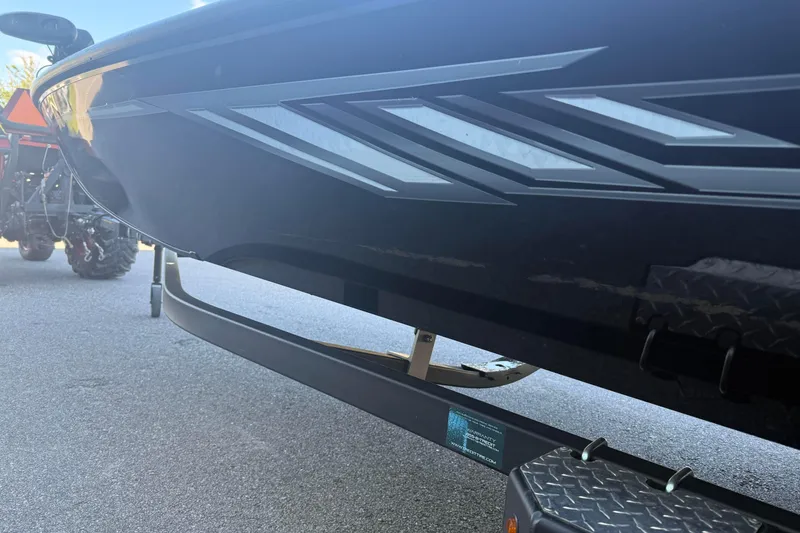 Slide: The Image of 2021 Crestliner XF 179 boat on trailer, showcasing sleek design and graphics. - 5