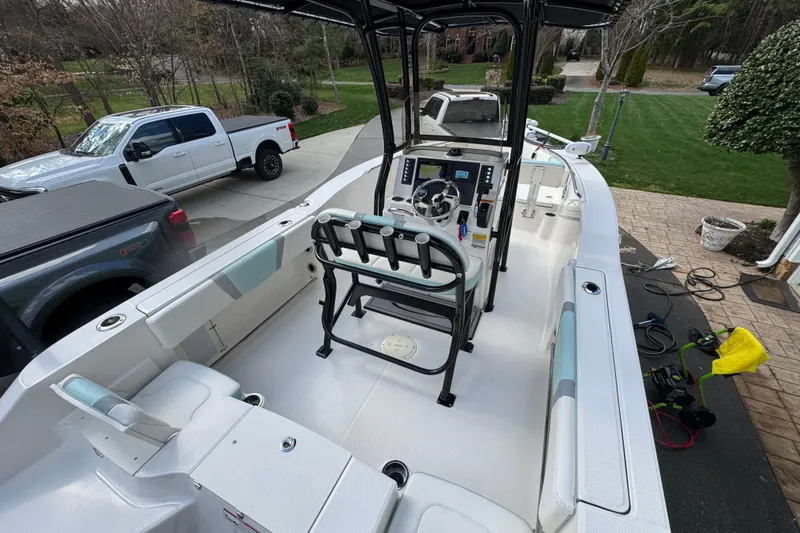 Slide: The Image of 2023 Robalo R200 Center Console boat in driveway, featuring spacious seating and modern controls. - 12