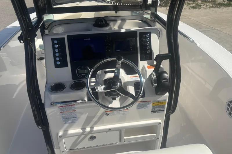 Slide: The Image of 2023 Robalo R200 Center Console boat dashboard with steering wheel and controls. - 6