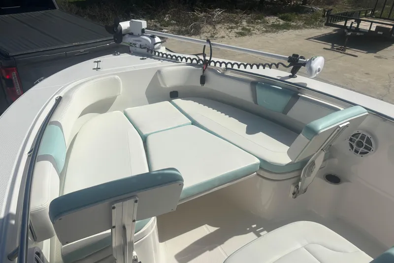 Slide: The Image of 2023 Robalo R200 Center Console boat with cushioned seating and fishing equipment. - 7