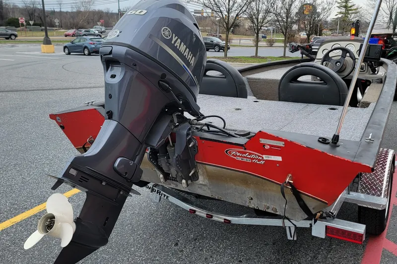 Slide: The Image of 2006 Tracker Pro Team 190 TX boat with Yamaha outboard motor in parking lot. - 2