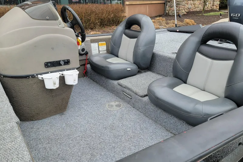 Slide: The Image of 2006 Tracker Pro Team 190 TX boat interior with gray seating and steering console. - 4