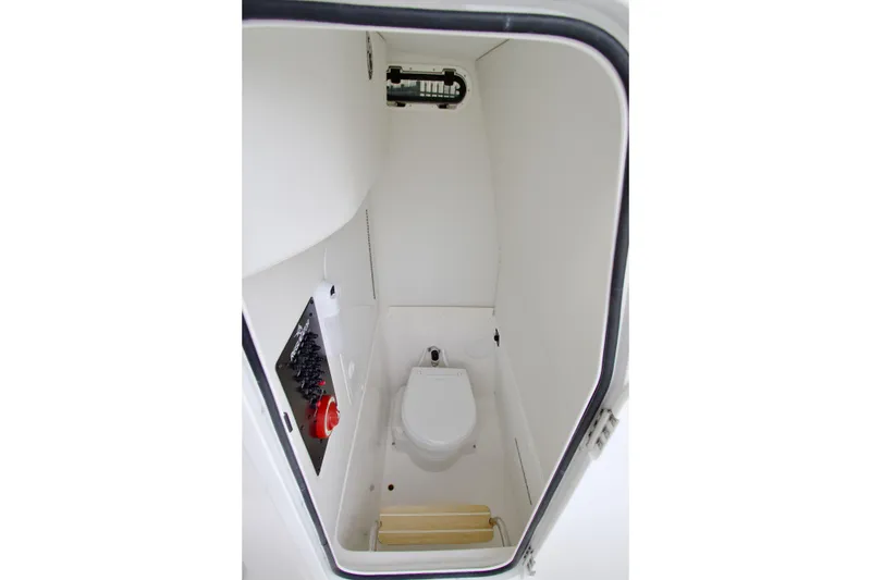 Slide: The Image of 2026 Regulator 23 boat interior with compact marine toilet and control panel. - 10