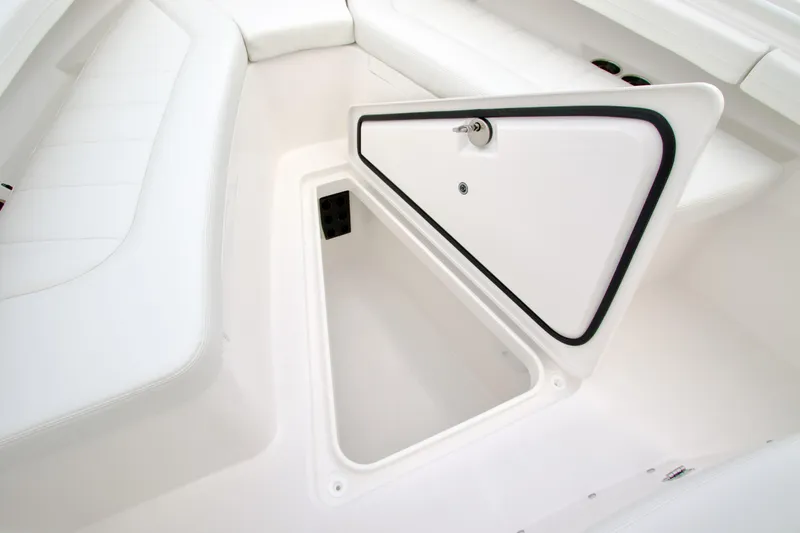 Slide: The Image of 2026 Regulator 23 boat storage compartment with open hatch, showcasing sleek white interior design. - 12