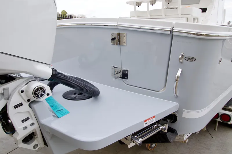 Slide: The Image of 2026 Regulator 23 boat stern with outboard motor and swim platform. - 14