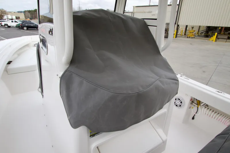 Slide: The Image of 2026 Regulator 23 boat console with protective cover in a marina setting. - 15