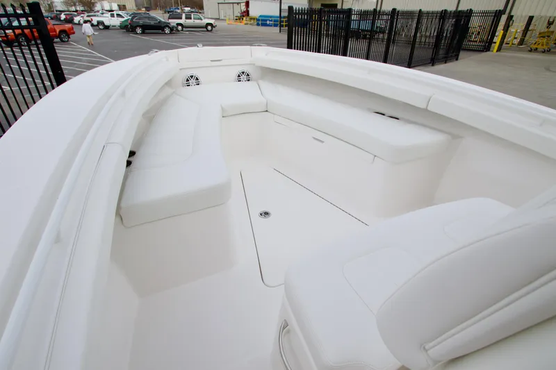 Slide: The Image of 2026 Regulator 23 boat interior with white seating and spacious deck layout. - 16