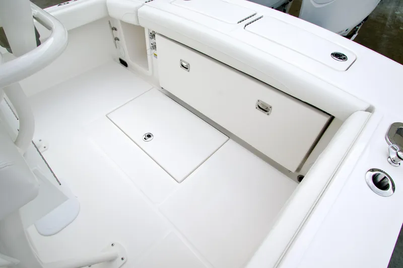 Slide: The Image of 2026 Regulator 23 boat interior with white seating and storage compartments. - 17