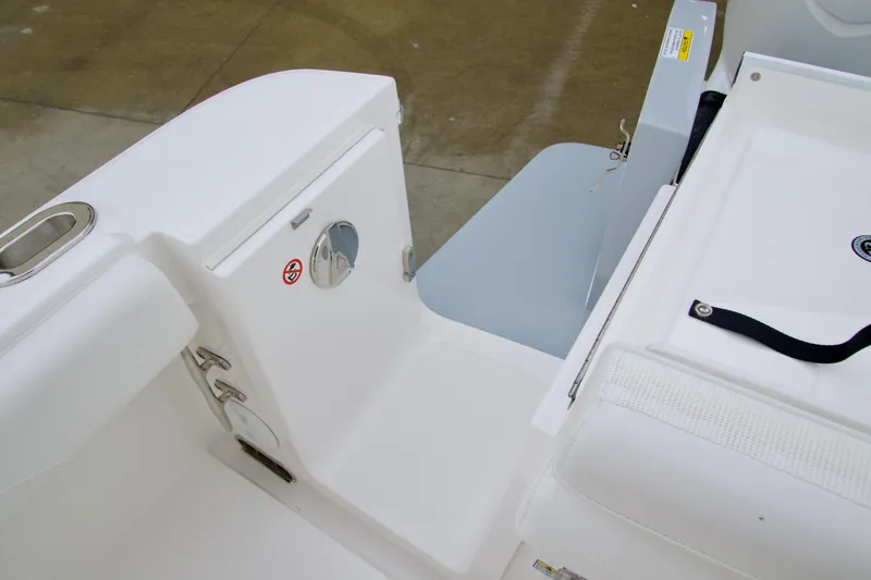 Slide: The Image of 2026 Regulator 23 boat interior, featuring sleek white seating and storage compartments. - 18