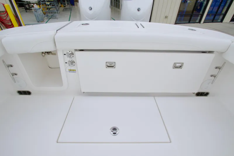 Slide: The Image of 2026 Regulator 23 boat interior with storage compartments and sleek white design. - 22