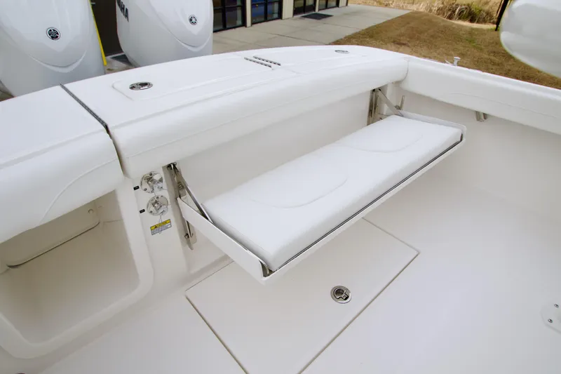 Slide: The Image of 2026 Regulator 23 boat with foldable white bench seat in cockpit area. - 23