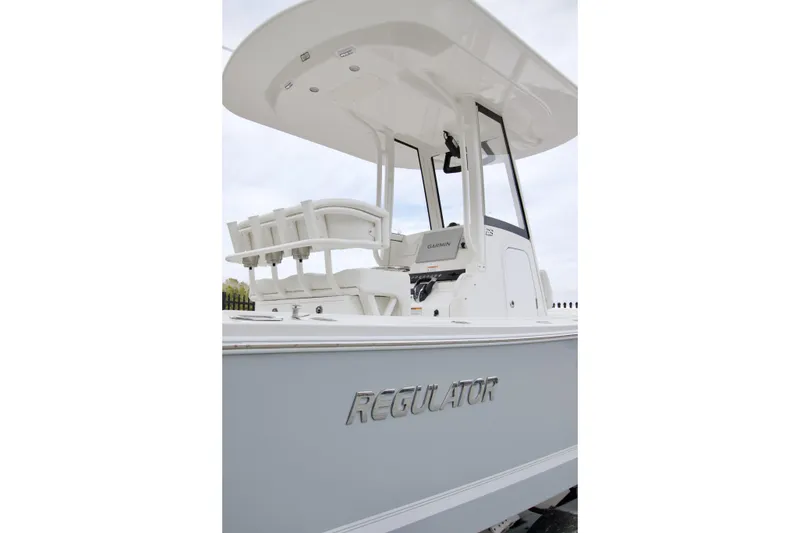 Slide: The Image of 2026 Regulator 23 boat with T-top and Garmin electronics, side view. - 3
