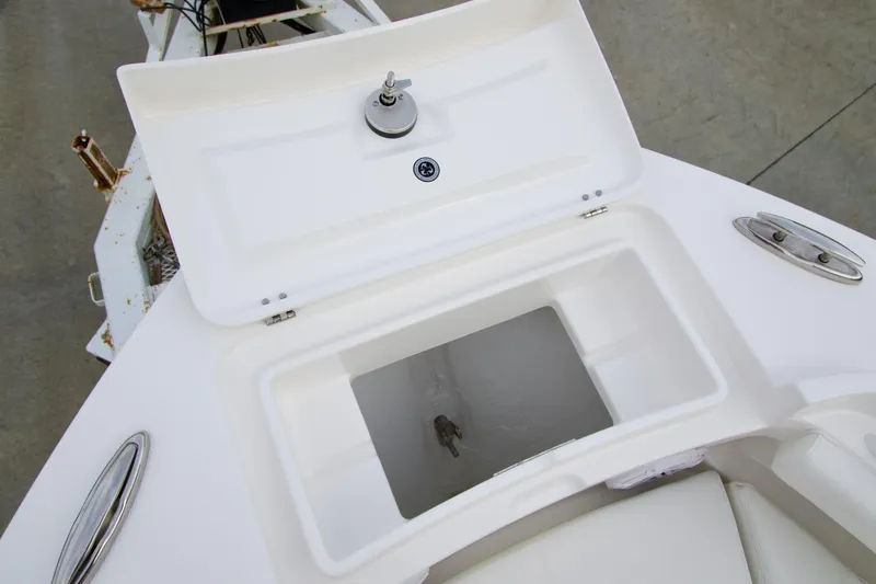 Slide: The Image of Open storage compartment on 2026 Regulator 23 boat, featuring a clean white interior. - 4
