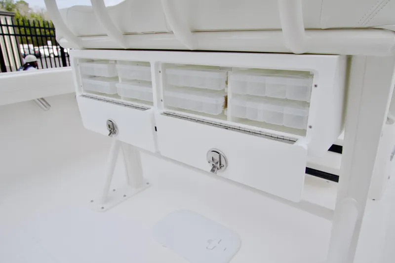 Slide: The Image of 2026 Regulator 23 boat storage compartments with secure latches and organized tackle boxes. - 6