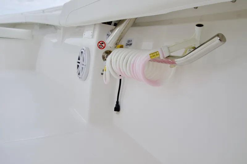 Slide: The Image of 2026 Regulator 23 boat interior with coiled hose and 120V charger. - 7