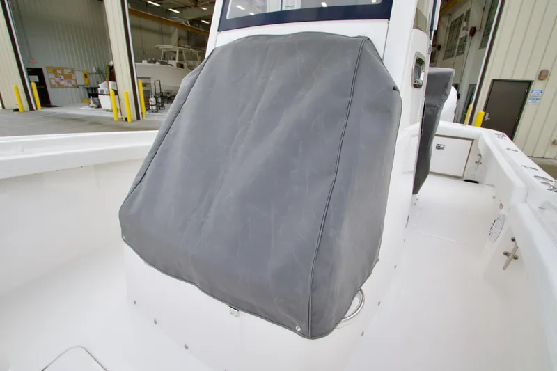 Slide: The Image of 2026 Regulator 23 boat console covered in a protective gray cover. - 8