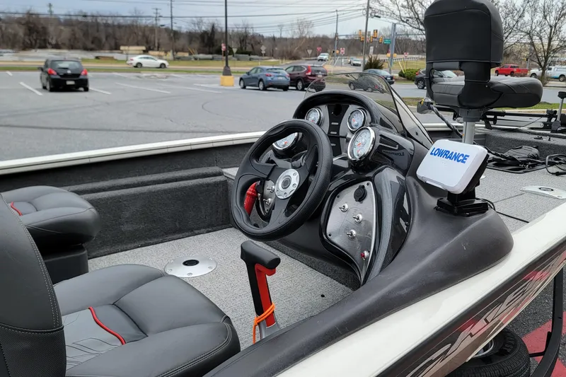 Slide: The Image of 2024 Tracker Pro Team 175 TF boat interior with steering wheel and Lowrance device. - 3