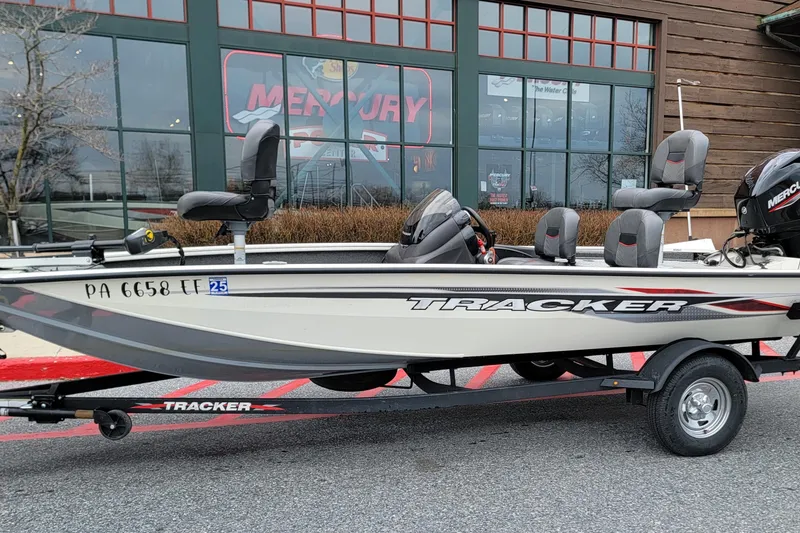 Slide: The Image of 2024 Tracker Pro Team 175 TF fishing boat on trailer, parked outside a store. - 8