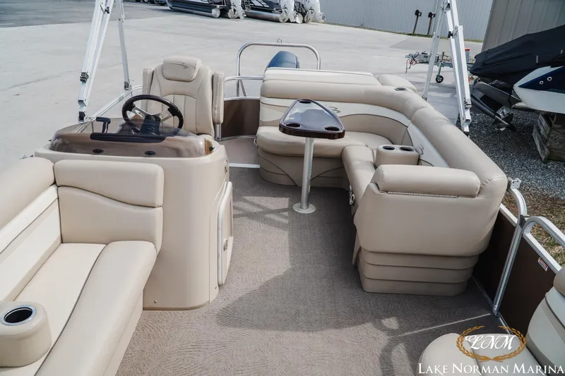 Slide: The Image of 2013 Bennington 20 SL pontoon boat interior with beige seating and steering console. - 12