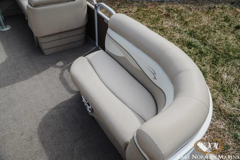 Slide: The Image of 2013 Bennington 20 SL boat interior with beige seating and carpet flooring. - 14