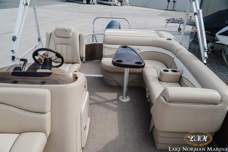Slide: The Image of 2013 Bennington 20 SL pontoon boat interior with beige seating and steering console. - 15
