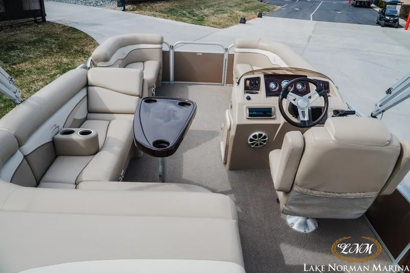 Slide: The Image of 2013 Bennington 20 SL pontoon boat interior with beige seating and steering console. - 5