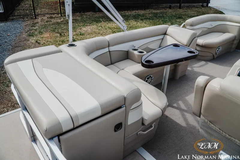 Slide: The Image of 2013 Bennington 20 SL pontoon boat with beige seating and a central table. - 6