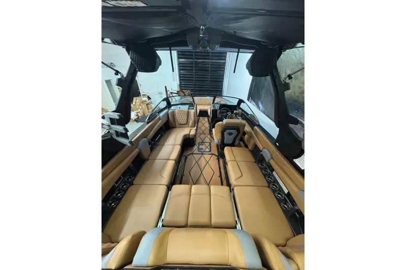 Slide: The Image of Luxurious interior of 2026 Malibu M230 boat with tan leather seating and modern design. - 5