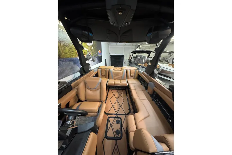 Slide: The Image of Luxurious interior of 2026 Malibu M230 boat with tan leather seating and modern design. - 7