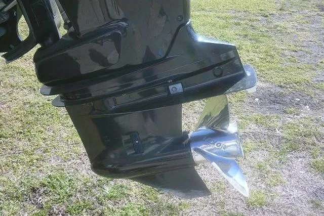 Slide: The Image of Close-up of a 2011 Carolina Skiff 258 DLV boat motor propeller on grass. - 11