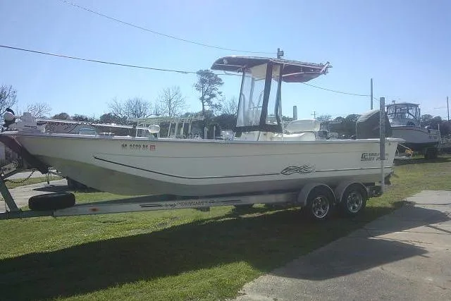 Slide: The Image of 2011 Carolina Skiff 258 DLV boat on trailer, parked outdoors. - 13