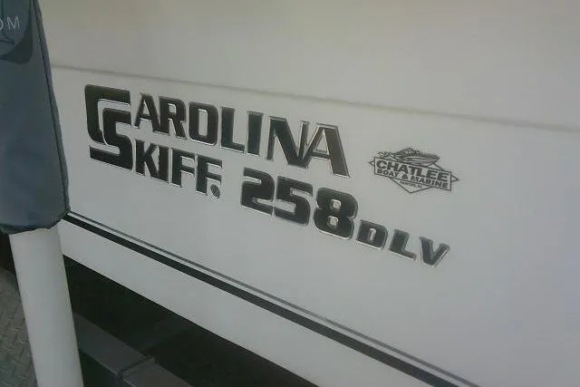 Slide: The Image of 2011 Carolina Skiff 258 DLV boat logo on white hull. - 16