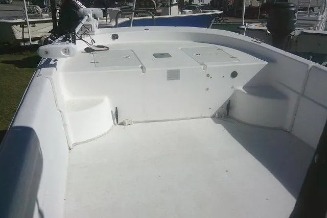 Slide: The Image of 2011 Carolina Skiff 258 DLV boat deck, featuring spacious seating and storage compartments. - 17