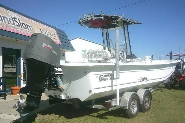Slide: The Image of 2011 Carolina Skiff 258 DLV boat with Suzuki outboard motor on trailer. - 2