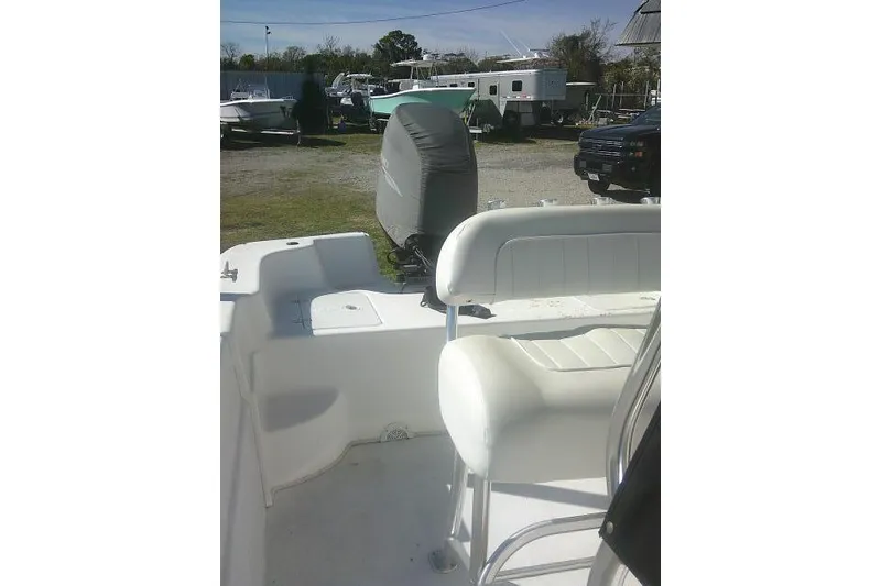 Slide: The Image of 2011 Carolina Skiff 258 DLV boat interior with seating and covered outboard motor. - 20