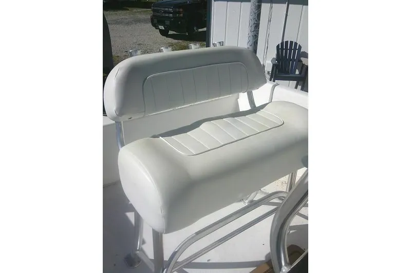 Slide: The Image of White cushioned seat on 2011 Carolina Skiff 258 DLV boat, outdoor setting. - 21