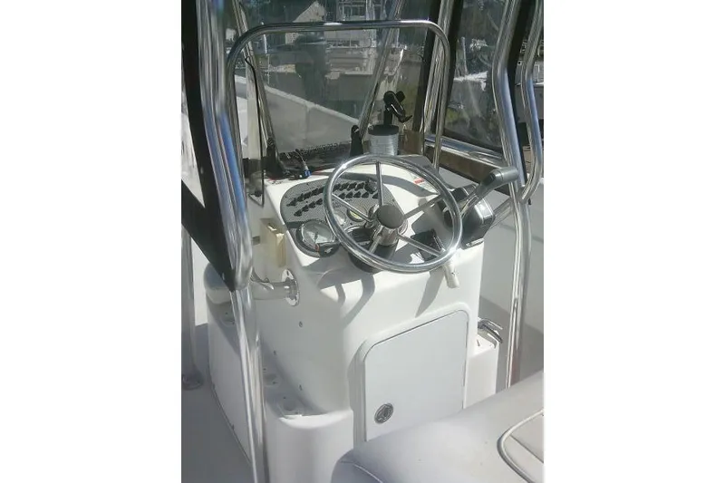 Slide: The Image of 2011 Carolina Skiff 258 DLV boat console with steering wheel and controls. - 23