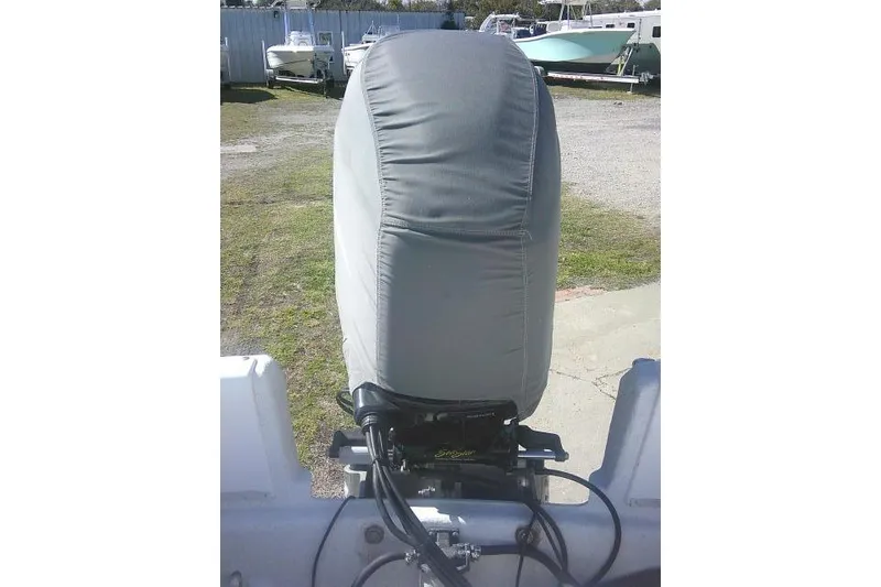 Slide: The Image of Covered outboard motor on a 2011 Carolina Skiff 258 DLV boat, parked outdoors. - 25