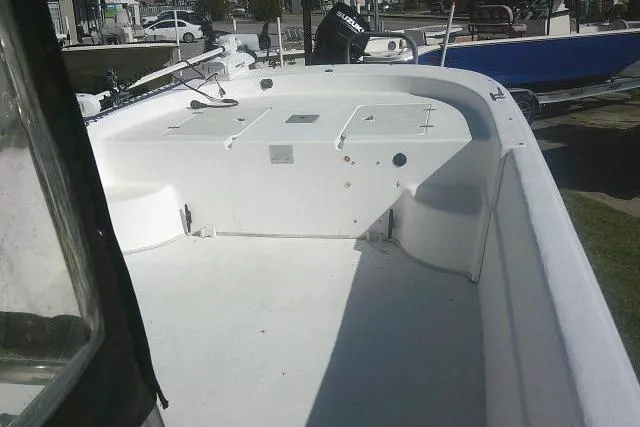 Slide: The Image of 2011 Carolina Skiff 258 DLV boat deck, spacious and clean, with visible storage compartments. - 28