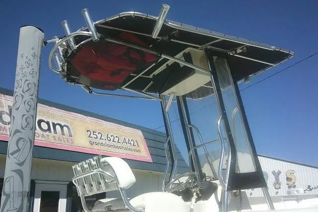 Slide: The Image of 2011 Carolina Skiff 258 DLV boat with T-top, displayed at dealership. - 3