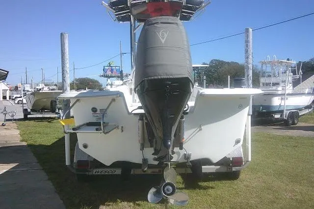 Slide: The Image of 2011 Carolina Skiff 258 DLV boat rear view with outboard motor on trailer. - 4