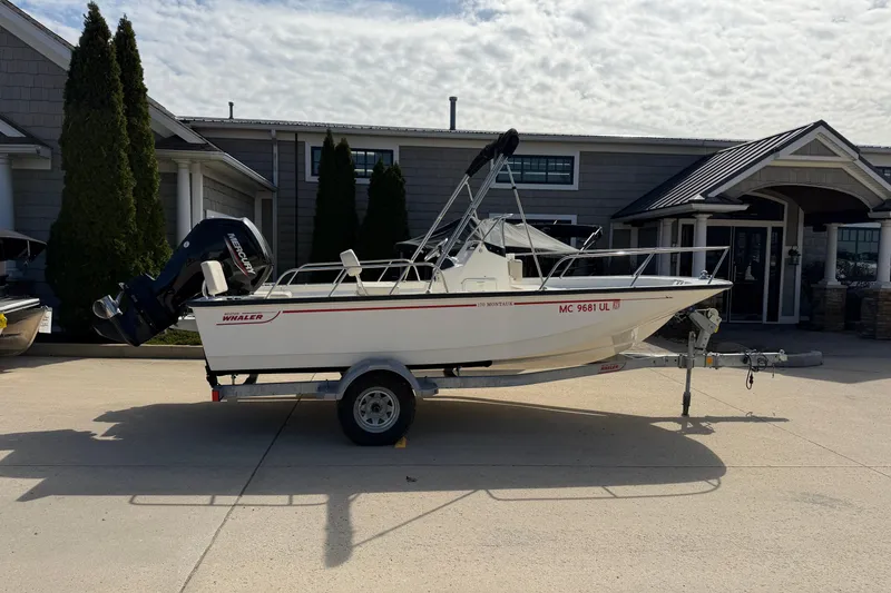 The Image of 2020 Boston Whaler 170 Montauk boat on trailer, parked outside a building. - 0