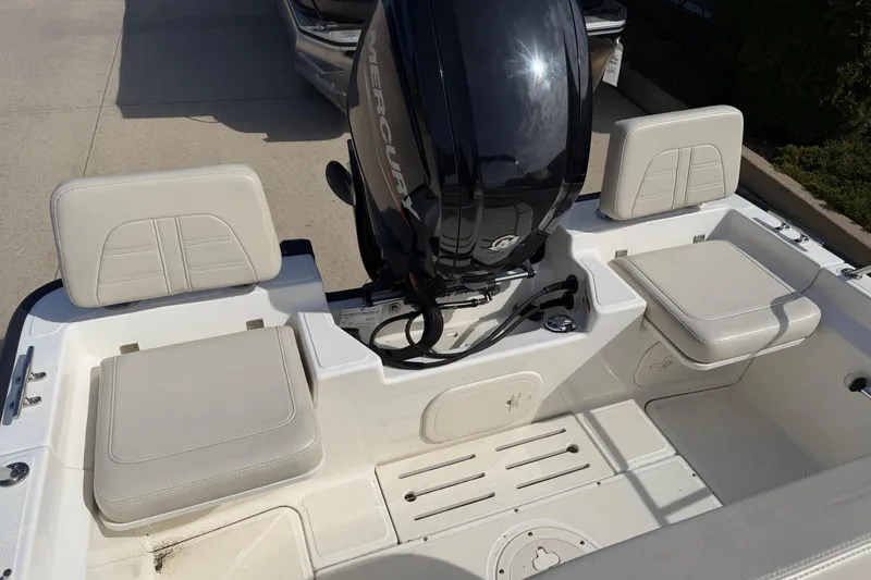 Slide: The Image of 2020 Boston Whaler 170 Montauk boat interior with Mercury engine and cushioned seating. - 11