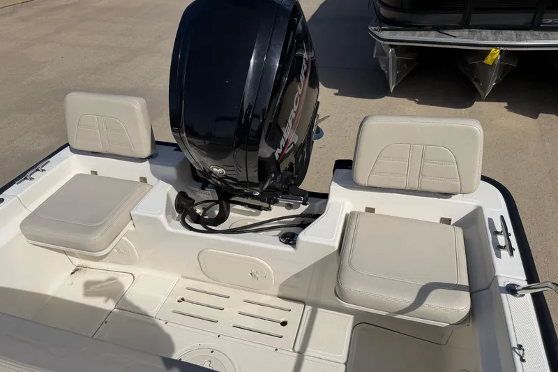 Slide: The Image of 2020 Boston Whaler 170 Montauk boat interior with Mercury engine and cushioned seating. - 12