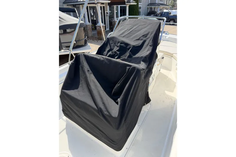 Slide: The Image of 2020 Boston Whaler 170 Montauk boat with covered console, docked outdoors. - 13